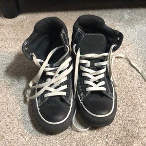 Woman’s black and white converse